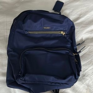Tumi navy blue and gold backpack